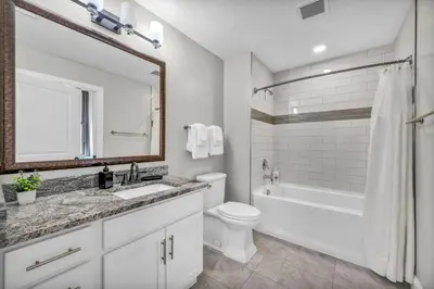 a bathroom with a sink and a tub and a toilet at Elegant Downtown Apartment | Paid Parking & Gym in Cleveland
