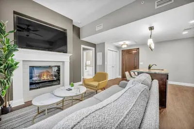 a living room with a couch and a fireplace at Elegant Downtown Loft w/ Parking & Gym in Cleveland