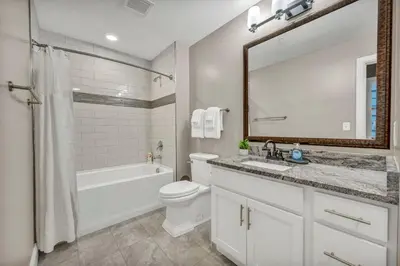a bathroom with a sink toilet and a mirror at Elegant Downtown Loft w/ Parking & Gym in Cleveland