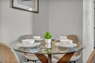a dining room table with chairs and a glass table top at Elegant Downtown Loft w/ Parking & Gym in Cleveland