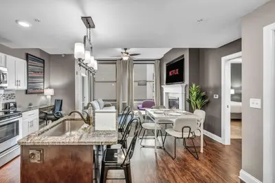 a kitchen and dining room with a table and chairs at Elegant 2BD Condo in the Heart of Downtown • Gym in Cleveland