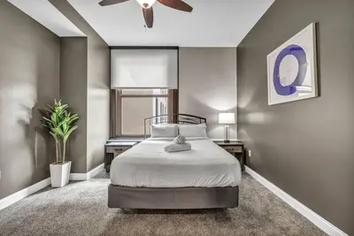 a bedroom with a bed and a ceiling fan at Elegant 2BD Condo in the Heart of Downtown • Gym in Cleveland