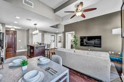 a living room with a couch and a table at Sophisticated Downtown Loft | Parking & Gym in Cleveland