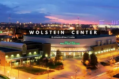 a building with a sign that reads woltten center at night at Sophisticated Downtown Loft | Parking & Gym in Cleveland