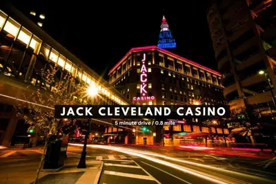 a street sign in front of a building at night at Sophisticated Downtown Loft | Parking & Gym in Cleveland