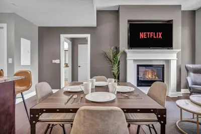 a dining room with a table and a fireplace at Luxury 2 BD Condo in the Heart of Downtown • Gym in Cleveland