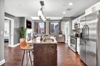 a kitchen with a sink and a refrigerator at Luxury 2 BD Condo in the Heart of Downtown • Gym in Cleveland