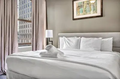 a bedroom with a white bed with a towel on it at Luxury 2 BD Condo in the Heart of Downtown • Gym in Cleveland