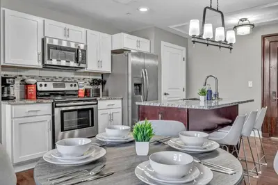 a kitchen with a table with dishes on it at Downtown Luxury Condo | Parking•Security•Gym in Cleveland