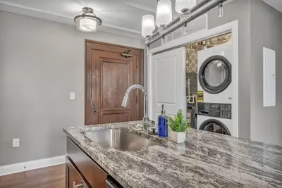a kitchen with a sink and a counter at Downtown Luxury Condo | Parking•Security•Gym in Cleveland