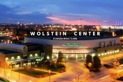 a building with a sign that reads wolfenstein center at night at Downtown Luxury Condo | Parking•Security•Gym in Cleveland