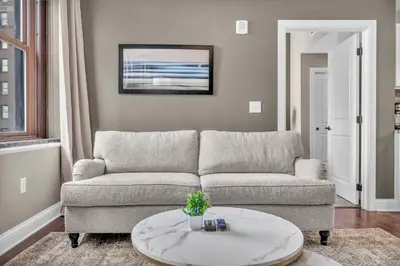 a living room with a couch and a table at Downtown Luxury Condo | Parking•Security•Gym in Cleveland