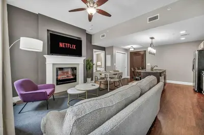 a living room with a couch and a fireplace at Upscale Downtown Loft | Parking • Gym in Cleveland