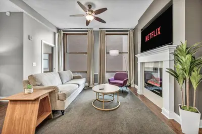 a living room with a couch and a fireplace at Upscale Downtown Loft | Parking • Gym in Cleveland