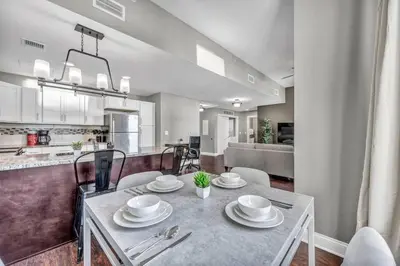 a dining room and kitchen with a table and chairs at Stunning Downtown Condo with Parking & Gym in Cleveland