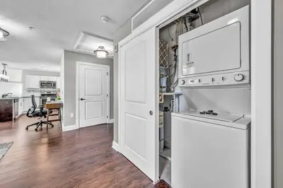 a kitchen with a white stove top oven next to a door at Stunning Downtown Condo with Parking & Gym in Cleveland