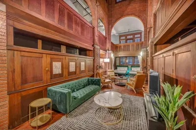 a living room with a green couch and a table at Unique 3BD Tremont Apartment in Cleveland