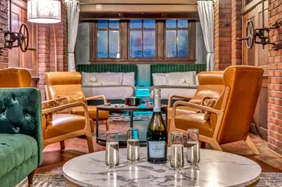 a room with a bottle of wine on a table at Unique 3BD Tremont Apartment in Cleveland