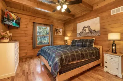 a bedroom with a bed in a log cabin at Whiskey Ridge in Logan