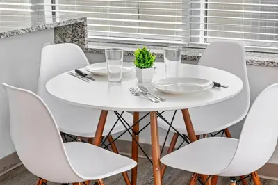 a white table and chairs in a room with a window at Bright Downtown 1BR l Free Parking l Fast Wi-Fi in Cleveland