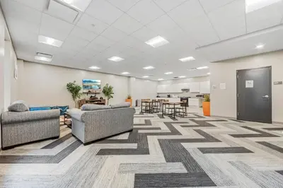 an office lobby with couches and chairs and tables at Bright Downtown 1BR l Free Parking l Fast Wi-Fi in Cleveland