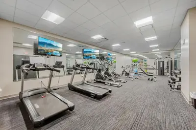 a gym with several treadmills and cardio machines at Bright Downtown 1BR l Free Parking l Fast Wi-Fi in Cleveland