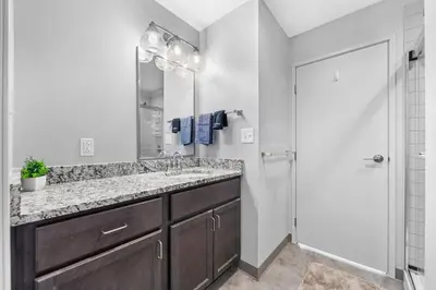 a bathroom with a sink and a mirror at Bright Downtown 1BR l Free Parking l Fast Wi-Fi in Cleveland