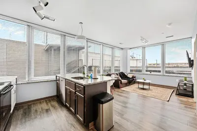 a kitchen and living room with a lot of windows at Bright Downtown 1BR l Free Parking l Fast Wi-Fi in Cleveland