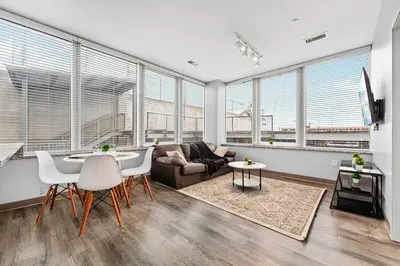 a living room with a couch and a table at Bright Downtown 1BR l Free Parking l Fast Wi-Fi in Cleveland