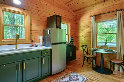 a kitchen with a refrigerator and a table in a cabin at Havenridge in Logan