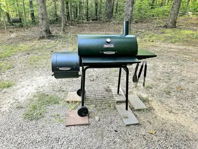 a grill sitting on the ground in a field at ForgetMeNot in Wellington