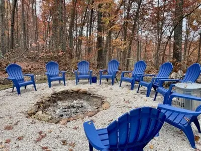 a group of blue chairs sitting around a fire pit at ForgetMeNot in Wellington