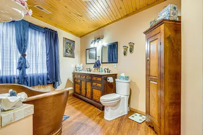 a bathroom with a tub and a toilet and a sink at Secluded, Waterfront Home with Patio in Craigville!