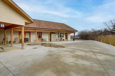 an empty driveway in front of a house at Secluded, Waterfront Home with Patio in Craigville!