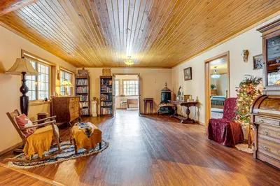 a large living room with a wooden ceiling at Secluded, Waterfront Home with Patio in Craigville!