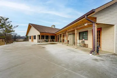 an empty driveway in front of a house at Secluded, Waterfront Home with Patio in Craigville!