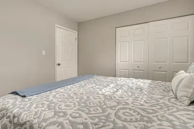 a bedroom with a large bed with white walls at 6 Mi to Downtown Columbus Quiet Home with Yard in Columbus