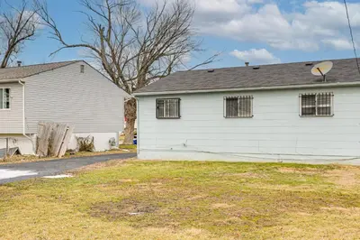 a white house with windows and a yard at 6 Mi to Downtown Columbus Quiet Home with Yard in Columbus
