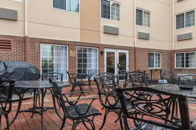 a patio with tables and chairs in front of a building at MainStay Suites Pittsburgh Airport in Imperial