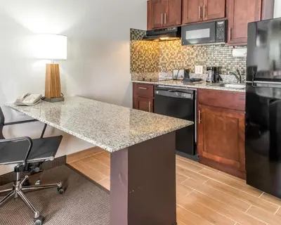 a kitchen with a granite counter top in a room at MainStay Suites Pittsburgh Airport in Imperial