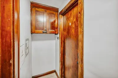 a kitchen with a refrigerator and a wooden cabinet at 3rd Floor Retreat Near Cleveland Clinic & Downtown in Shaker Heights
