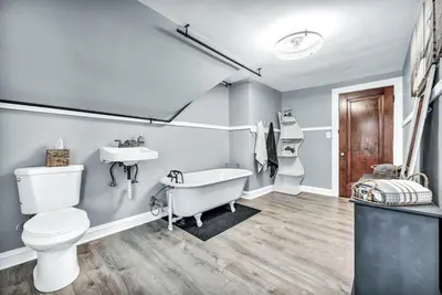 a bathroom with a tub and a sink and a toilet at 3rd Floor Retreat Near Cleveland Clinic & Downtown in Shaker Heights