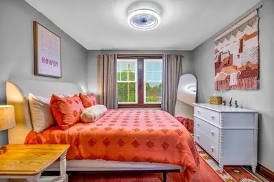 a bedroom with a bed and a dresser and a window at 3rd Floor Retreat Near Cleveland Clinic & Downtown in Shaker Heights