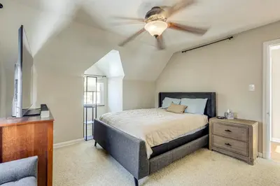 a bedroom with a ceiling fan and a bed at Cincy Area Bungalow with Deck and Yard, Pets Welcome! in Covington