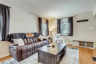 a living room with a couch and a coffee table at Cincy Area Bungalow with Deck and Yard, Pets Welcome! in Covington