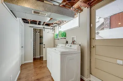 a laundry room with a washer and dryer at Cincy Area Bungalow with Deck and Yard, Pets Welcome! in Covington