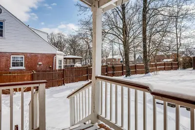 a porch covered in snow in front of a house at Cincy Area Bungalow with Deck and Yard, Pets Welcome! in Covington