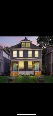a large house with a clock on top of it at 230 Entire Complex 2 homes side by side in Columbus