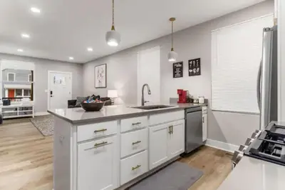 a kitchen with white cabinets and stainless steel appliances at 230 Entire Complex 2 homes side by side in Columbus