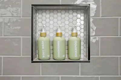 three green bottles sitting on a shelf in a bathroom at 293 Perfect for companies in Columbus